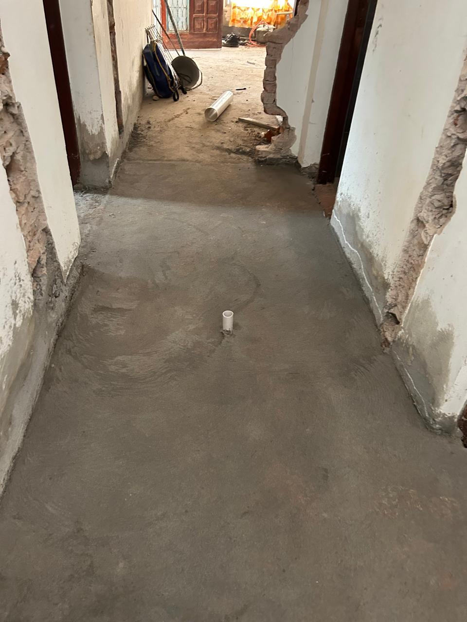 Floor preparation and a pipe outlet inside the house