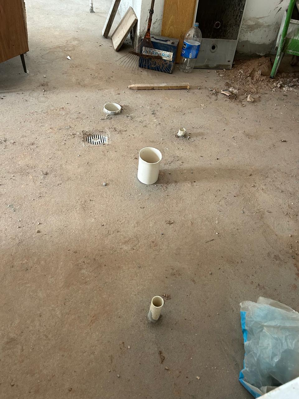 A closer view of pipe outlets and the floor