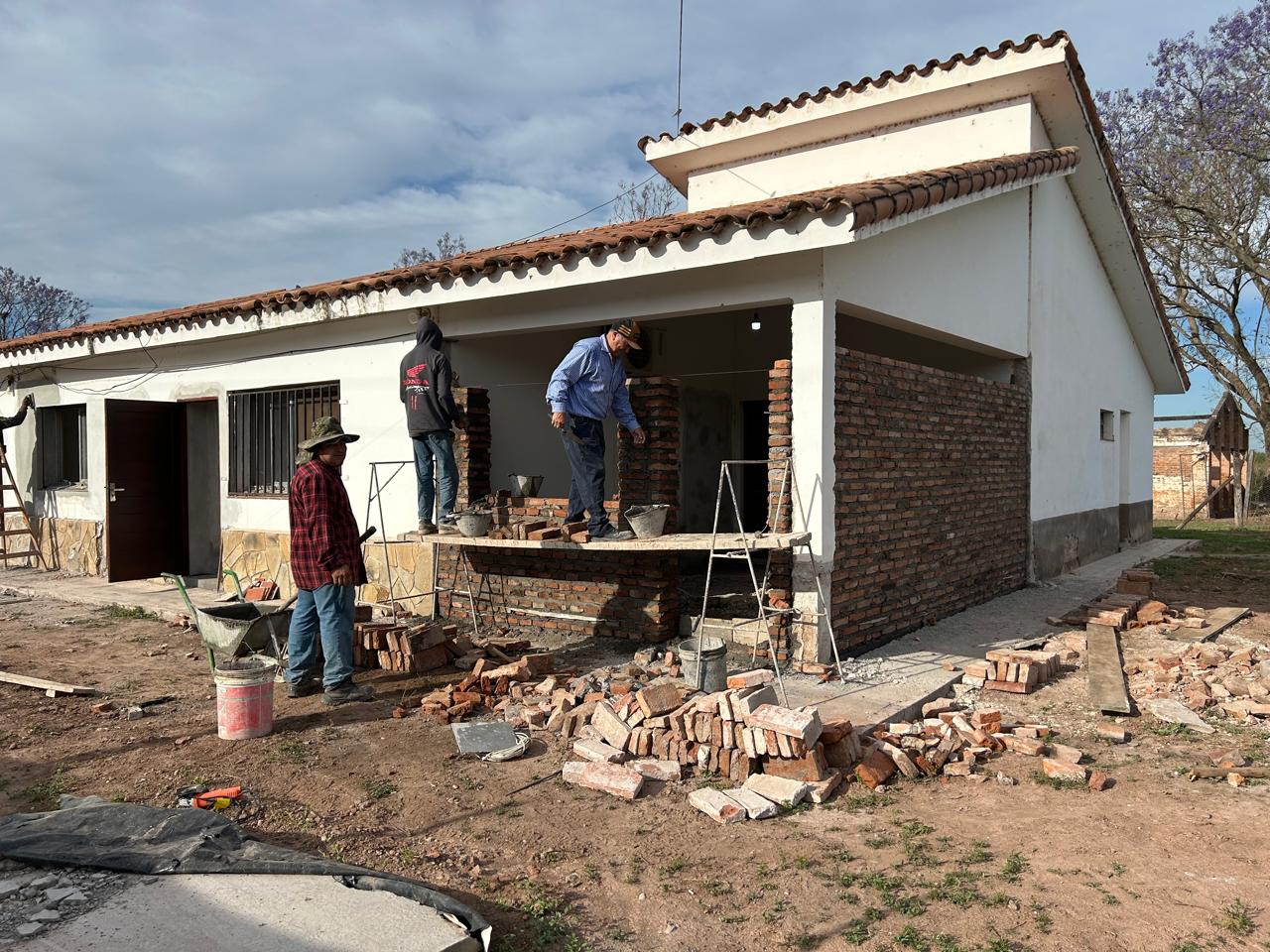 Workers and new brickwork in the veranda