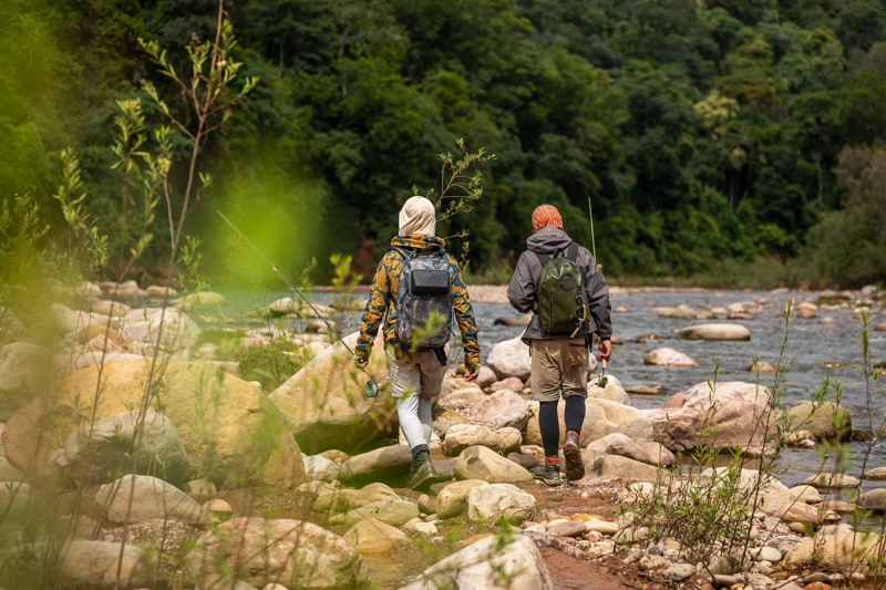 The group explores a stretch of rocks and water.