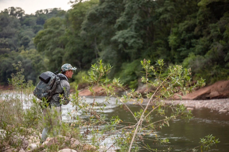 An angler beside the riverbank.