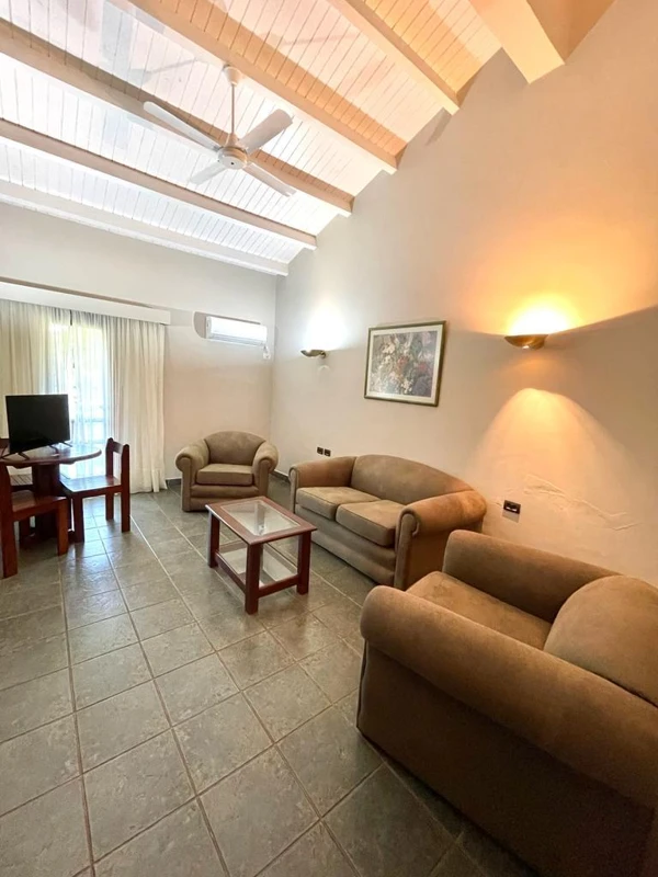 Sofas and a table in an indoor space.