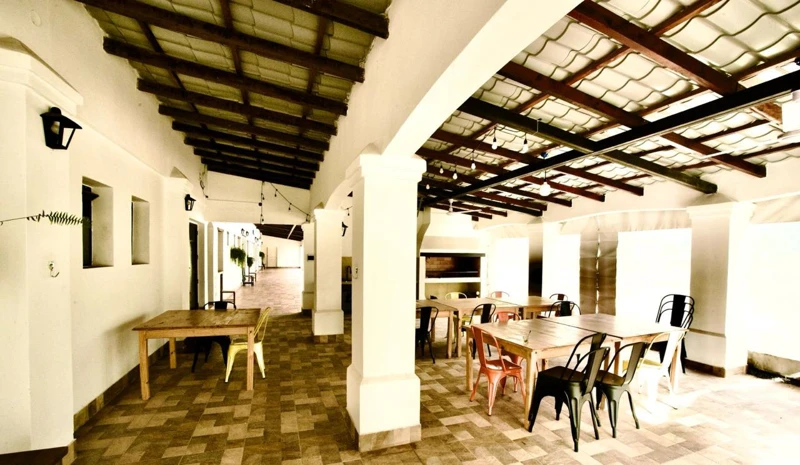 Tables and chairs in a space open to the garden.