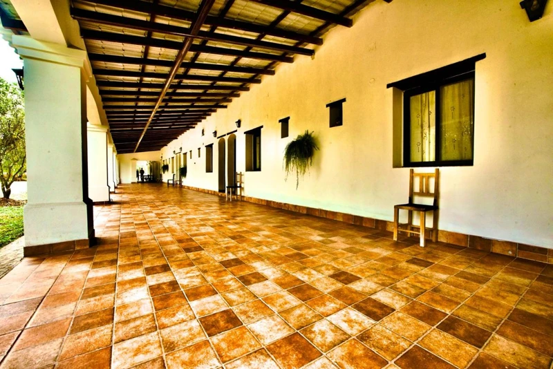 A covered walkway beside the rooms.