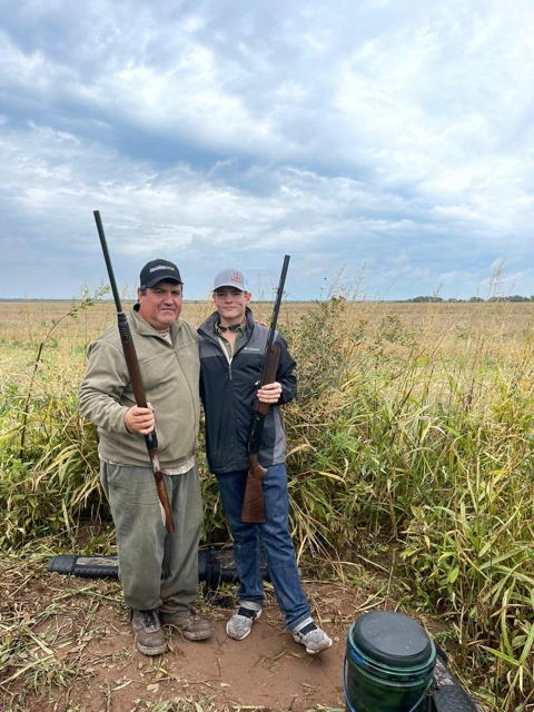 Two participants in the field during a hunting outing.